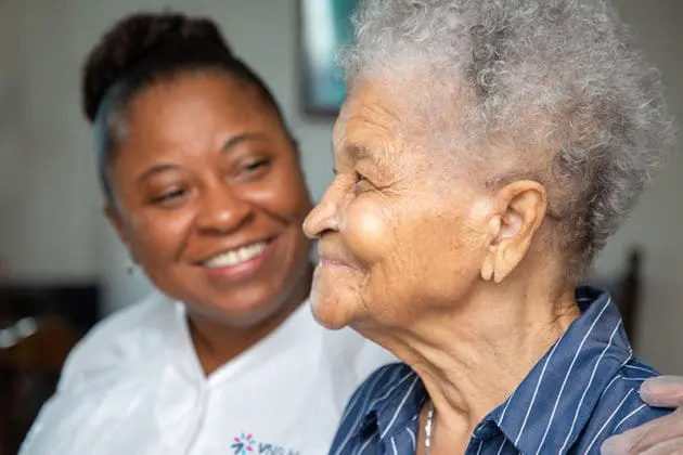 A VNS Health nurse smiling with her patient.