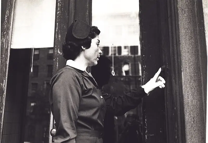 A VNS Health nurse ringing a doorbell.