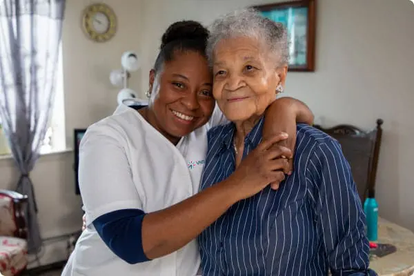 VNS Health team member hugging her patient.