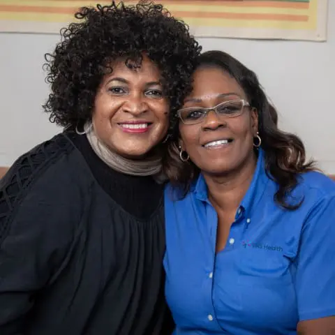 Two VNS Health team members hugging.