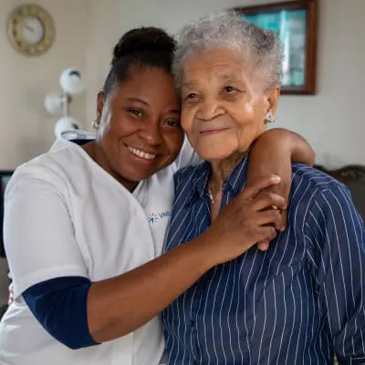 VNS Health team member hugging her patient.