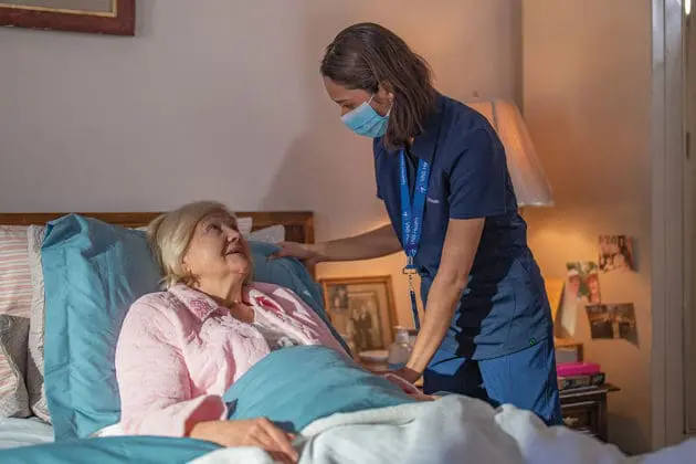 Team member helps a hospice care patient.