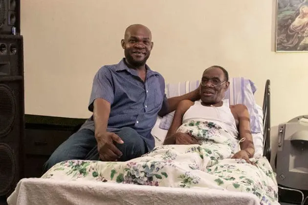 A son with his elderly father in hospice care.