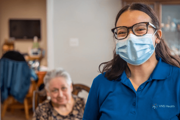 photo of a VNS Health nurse in a home with an elderly patient
