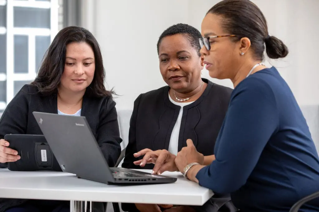 Three VNS Health employees in a meeting.