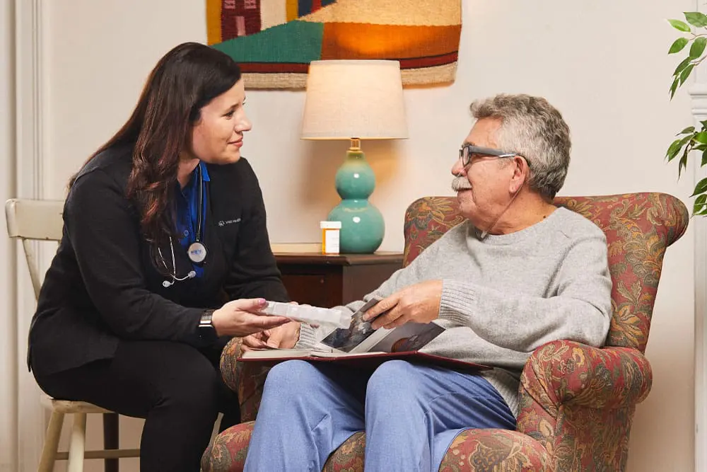 A VNS Health home health aide assisting her patient with medication.