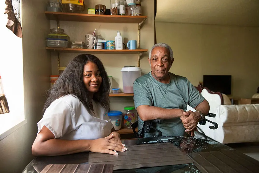 A VNS Health home health aide with her patient at home.