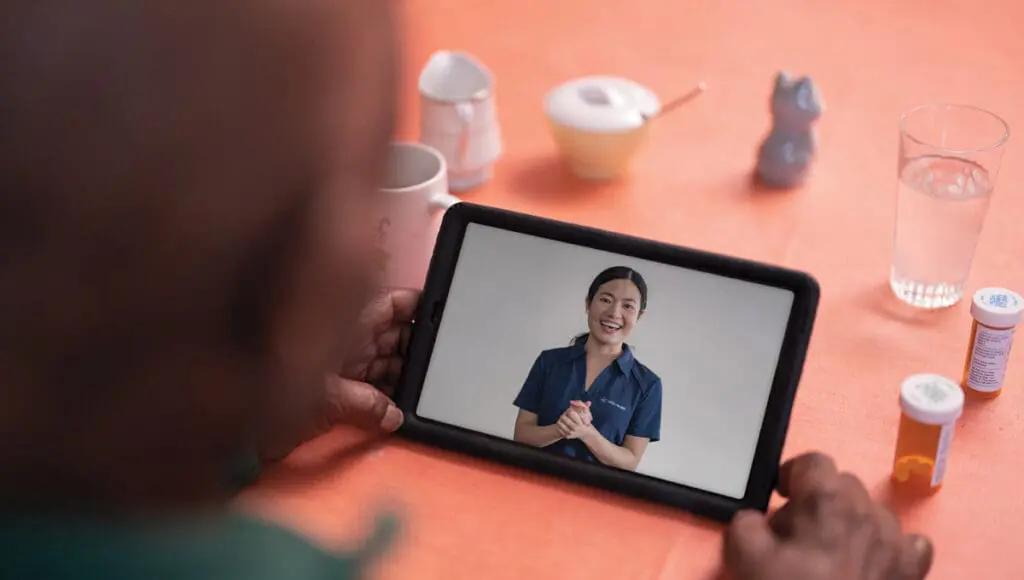 A VNS Health patient using a tablet for her telehealth visit.