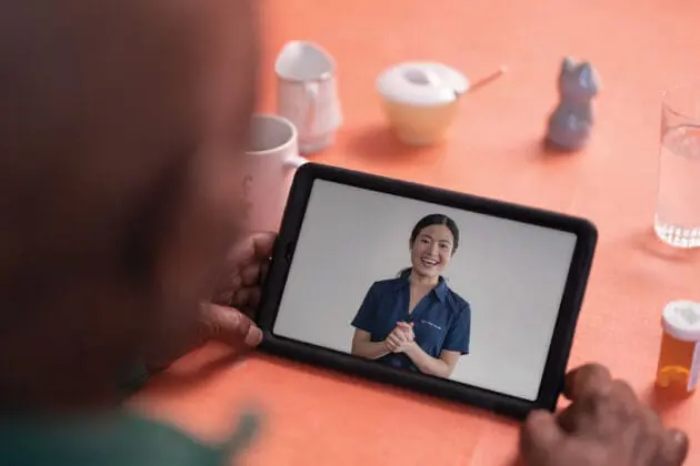 A VNS Health patient using a tablet for her telehealth visit.