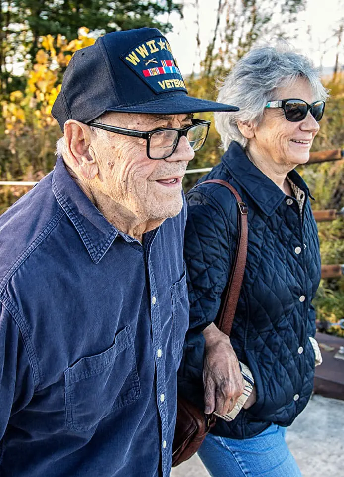 A Veteran and his partner walking outside.