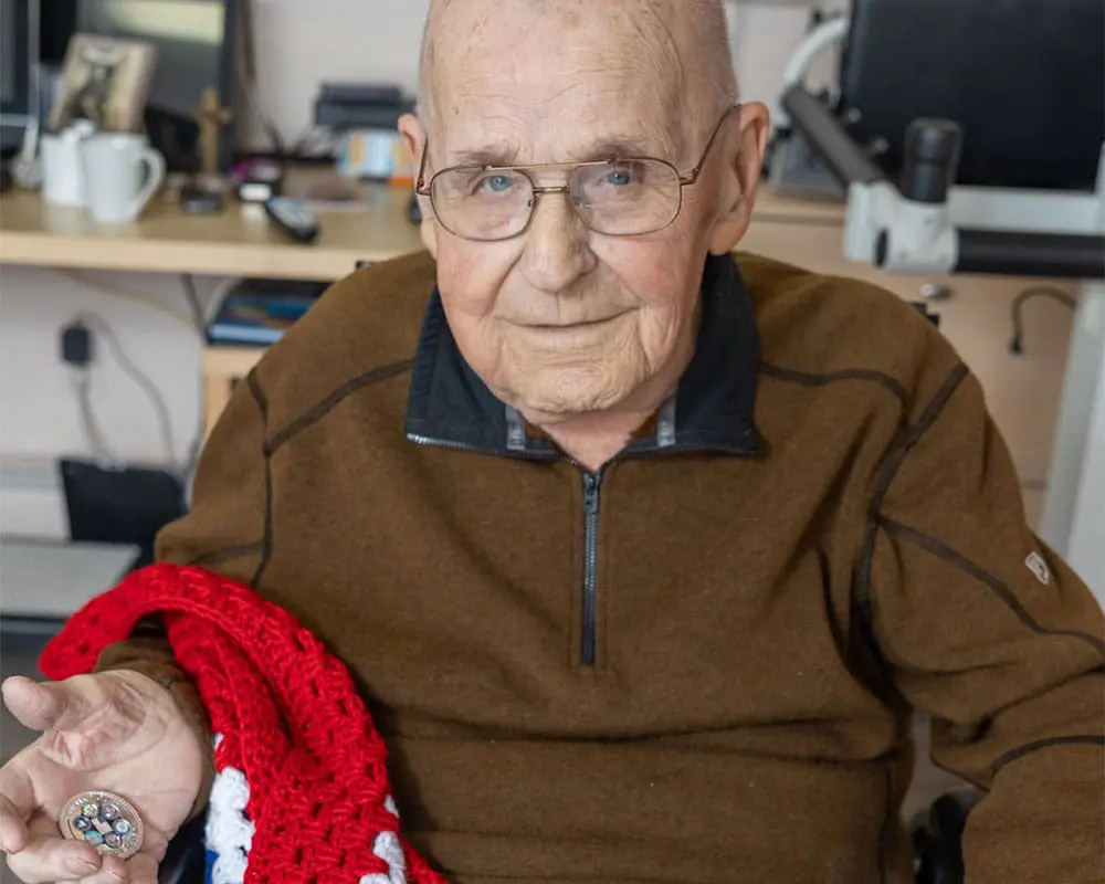 elderly veteran holding medal