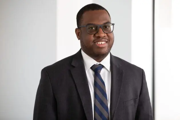 Headshot of EVP and CFO Keith Patterson wearing a black suit.