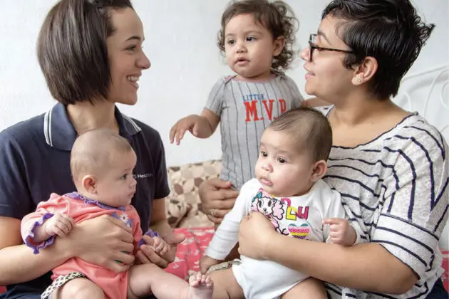 mother and nurse holding babies