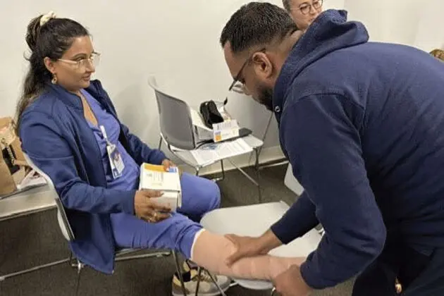 woman having leg bandaged