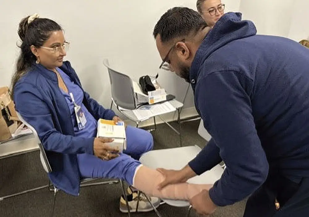 woman having leg bandaged