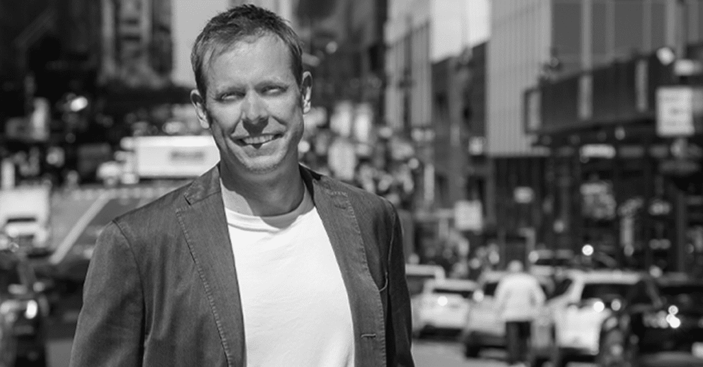 Black and white photo of VNS Health CEO Dan Savitt standing on a New York City Street.