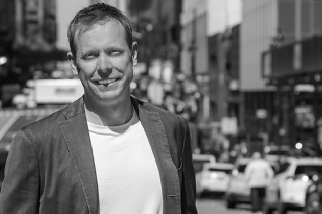 Black and white photo of VNS Health CEO Dan Savitt standing on a New York City Street.