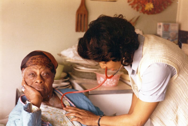 Nurse checking woman's heart