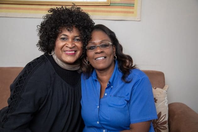 A patient of the Gender Affirmation Program and her nurse sit close together.