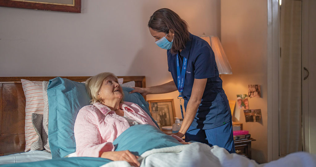 Team member helps a hospice care patient.