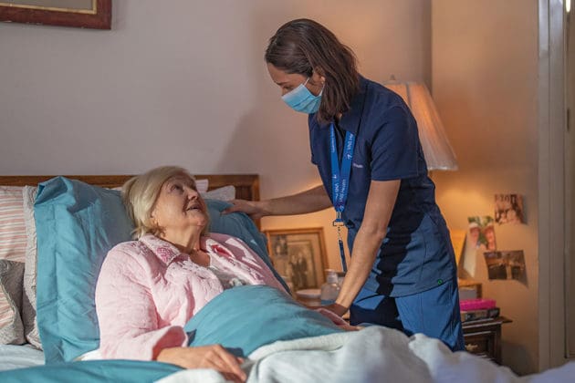 Team member helps a hospice care patient.