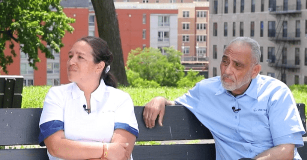 Diverse VNS Health team members sitting on a bench outside during an interview