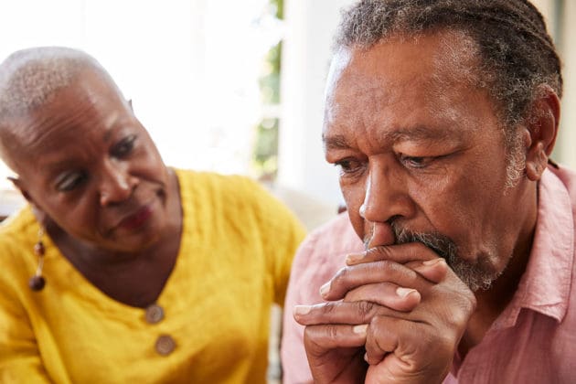 woman looking at frowning man