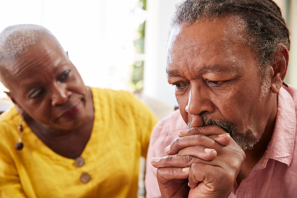 woman looking at frowning man