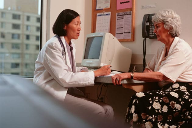 elderly woman talking to doctor