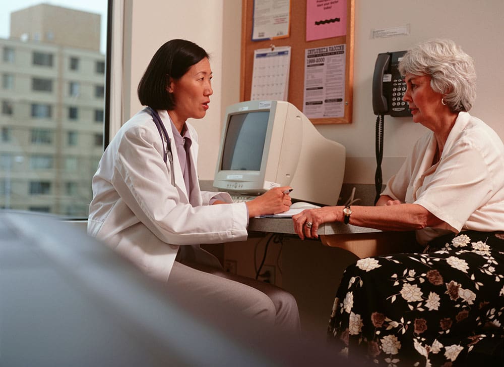 elderly woman talking to doctor