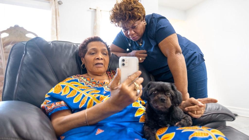 woman holding cell phone nurse looking over her shoulder