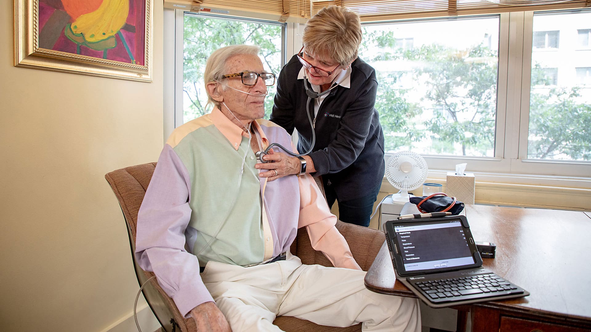 A caregiver checks the heartbeat of a patient