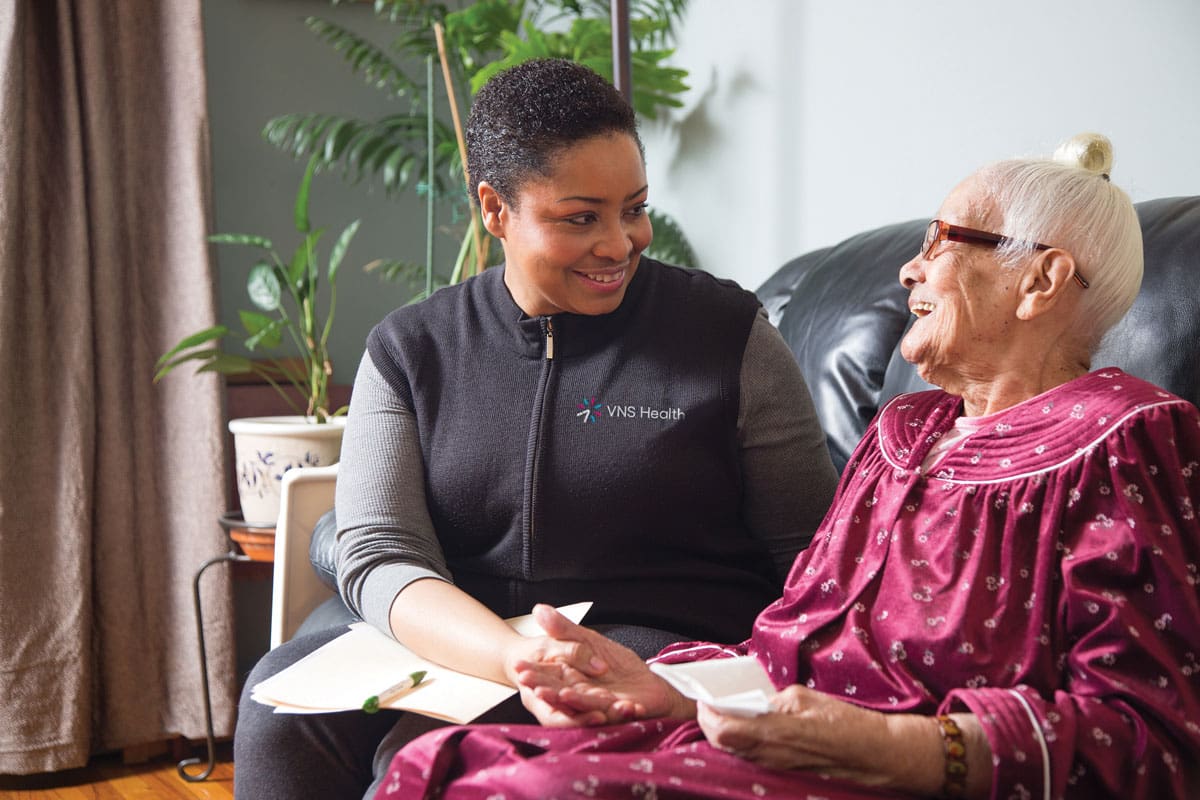A caregiver sits with a patient