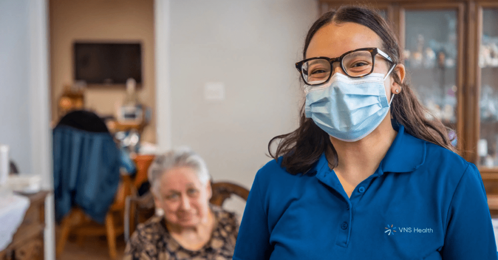 photo of a VNS Health nurse in a home with an elderly patient