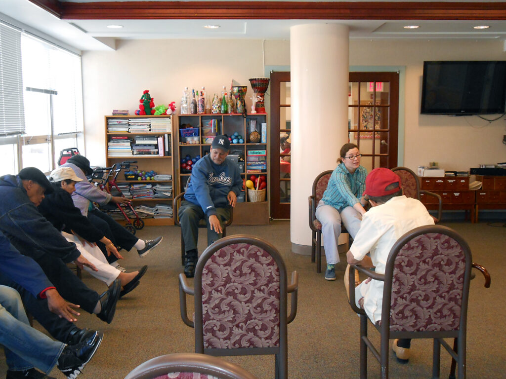 VNS Health volunteer teaching older adults chair exercises