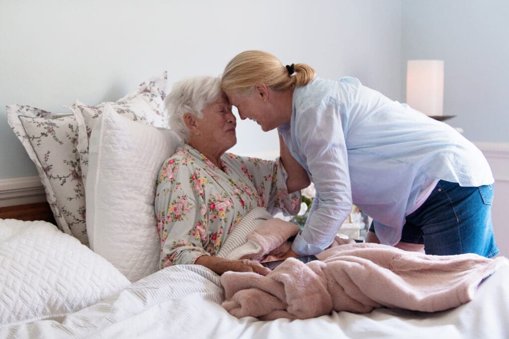 emotional moment between daughter and elderly mother